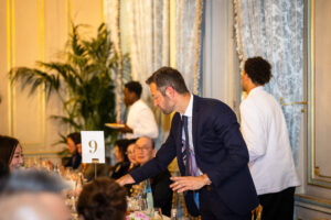 Close-up magician for corporate events, performing a magic trick just inches from the guests.